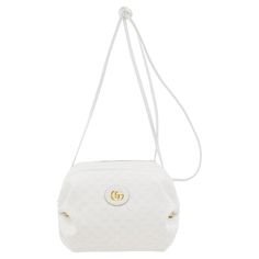 White Gucci supreme coated canvas shoulder bag featuring an all over logo pattern in tan. Tonal grained leather trim throughout. Logo hardware at shoulder strap. Logo plaque at face. Hoop hardware and ruched detailing at sides. Zip closure. Three card slots and detachable lanyard clasp on curb chain at interior. Navy blue and pink floral-patterned textile lining. Antiqued gold-tone hardware. Excellent vintage condition. Gucci by Alessandro Michele. Made in Italy. Sold with original dust bag. 11" White Sling Bag, Gucci Crossbody Bag, Gucci Crossbody, Gucci Outfits, Gucci Tote, Pink Floral Pattern, Ostrich Leather, Alessandro Michele, Logo Pattern