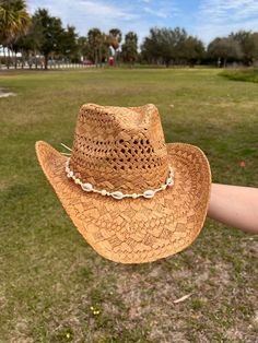 brown straw cowboy hat cowrie shell detail 100% paper Country Concert Hats, Shell Cowboy Hat, Cowgirl Hat Straw, Coastal Cowgirl Hat Ideas, Coastal Cowgirl Bride, Straw Cowboy Hat Decorating Ideas, Brown Fedora Straw Hat For Western-themed Events, Western Style Natural Color Paper Straw Hat, Western Style Natural Paper Straw Hat