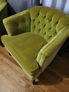 a green chair sitting on top of a hard wood floor