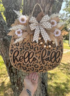 a hand holding up a wooden sign that says red face on it's side