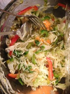 a glass bowl filled with shredded vegetables on top of a table