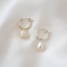 Sleek and subtle, these hoop earrings showcase the irregularities and organic form of these keshi pearls. Made of sterling silver and genuine freshwater pearls. Hoop measures 15mm in diameter while pearls measure 7-9mm in diameter. --------------------♥ PROMOS ♥-------------------- Want 10% off? Join the mailing list by visiting http://bit.ly/vedern . Just leave me a note at checkout if you have any problems applying discount codes. --------------------♥ BUY WITH CONFIDENCE ♥-------------------- Silver Earrings With Pearls, Dainty Silver Earrings Aesthetic, Silver Earrings Pearl, Minimal Silver Earrings, Pearl And Silver Earrings, Pearl Drop Earrings Silver, Sterling Silver Hoop Earrings With Pearl Drop For Gift, White Teardrop Hoop Earrings As Gift, Gift Sterling Silver Hoop Earrings With Pearl Drop