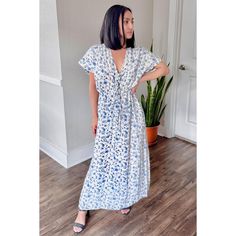 Radiate summer vibes with our 'Gathered Maxi Dress in Blue Florals.' Crafted from 100% Bemberg™ Crepe, this dress in white and blue exudes summery elegance. Whether worn solo or as a chic beach cover-up, its relaxed fit and drawstring waist ensure comfort and style. Featuring side slits and pockets on both sides, this maxi dress is a must-have addition to your summer wardrobe for beach days or casual outings. Light Blue V-neck Maxi Dress For Beach, Flowy Maxi Dress For Daytime Summer, Relaxed Fit Breezy Maxi Dress For Day Out, Blue Spring Beachwear Maxi Dress, Spring Short Sleeve Maxi Beach Dress, Spring Beachwear Maxi Dress With Short Sleeves, Blue Beachwear Maxi Dress For Spring, Breezy Relaxed Fit Maxi Dress, Blue Maxi Beach Dress For Spring