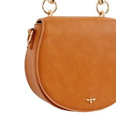 Crafted from certified vegan leather in classic tan, this curved satchel design evokes a sense of country life, reminiscent of a classic equestrian saddle bag. Complete with a top handle, an adjustable cross-body strap and a magnetic fastening, all designed to keep your most precious treasures safe and secure. Wipe clean with damp cloth Brown Satchel With Round Handle For On-the-go, Travel Shoulder Bag With Horsebit Detail, Classic Everyday Saddle Bag With Detachable Handle, Everyday Crossbody Bag With Horsebit Detail, Classic Brown Shoulder Bag With Horsebit Detail, Travel Satchel Shoulder Bag With Horsebit Detail, Travel Shoulder Bag With Horsebit Detail Satchel, Cognac Saddle Shoulder Bag For Everyday, Brown Shoulder Bag With Horsebit Detail