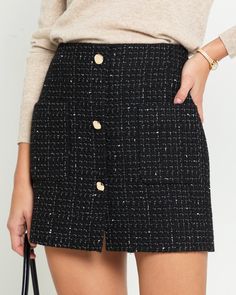 Product Details Elevate your style with the Renni Mini Skirt. Crafted from luxurious tweed material, this high-waisted skirt features front gold button details for a chic touch. - Front pockets- Back zipper- Lined- Content: Fabric: 80% Acrylic, 20% Wool; Lining: 100% Polyester- Care: Wash cold + dry flat Style# C24WSKH0460G Fit Notes - Model wearing a size S - Model measurements: 5'10'' Height / 32'' Bust / 24'' Waist / 34'' Hips- Garment measurements: Size Length Waist XS 40 69.9 S 40.6 74.9 M Winter Mini Skirt, Winter Mini Skirts, Black Tweed Skirt, Aesthetic Office, Tweed Material, Quilted Skirt, Black Tweed, Classy Fashion, Tweed Skirt