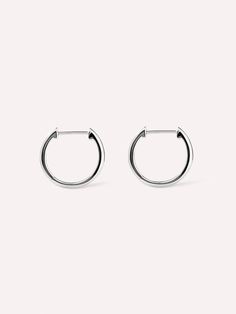 Crafted in recycled sterling silver and dipped in rhodium for a high-polish finish, our small slim endless hoops are perfect for stacking with other earrings. Each pair is carefully crafted and hypoallergenic, making them a versatile addition to your everyday wear. Wear these small slim endless hoops with other silver jewelry for an edgy, futuristic look.  Crafted in 100% recycled sterling silver  Lightweight & hypoallergenic  High-polish rhodium finish Timeless Silver Tarnish Resistant Hoop Earrings, Minimalist Nickel-free Huggie Earrings For Formal Occasions, Minimalist Nickel Free Huggie Earrings For Formal Occasions, Sterling Silver Polished Earrings For Everyday, Sterling Silver Earrings With Polished Finish For Everyday, Silver Minimalist Huggie Earrings For Formal Occasions, White Gold Huggie Earrings With Sterling Silver, Sleek White Gold Jewelry For Everyday Wear, Everyday Sleek White Gold Jewelry