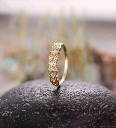 a gold ring sitting on top of a rock