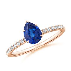 an oval blue sapphire and diamond ring in 18k rose gold with side stones on the band