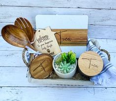 wooden utensils in a basket with names on them and succulents