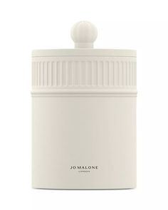 the jar is white and has a lid on it, with a small round knob at the top