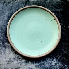 a green bowl sitting on top of a table