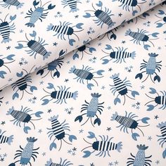 a blue and white fabric with crabs on it