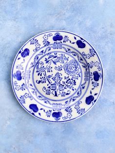 a blue and white plate sitting on top of a table