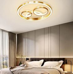 a modern bedroom with round lights above the bed