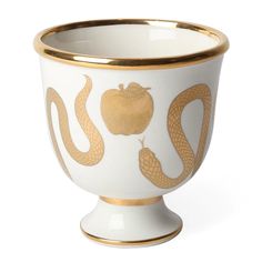 a white and gold vase with two snakes on the side, one in the shape of an apple