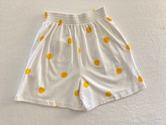 Vintage 1990's white summery elastic waist wide leg shorts with large yellow polka dots and yellow bow on back pocket by Betty Blue Made in Portugal 100% Cotton Good vintage condition with no rips or stains Tag shows Medium Measurements (laying flat): Waist: 13" - 16" Rise: 15" Length: 18 1/4" Inseam: 5 1/4" Our items are vintage, older and/or pre-loved and may show signs of age. Items may have some imperfections, including small holes, marks or stains. We do our best to note all flaws and pictu Polka Dot Bottoms For Vacation In Spring, Polka Dot Bottoms For Summer Vacation, Polka Dot Summer Bottoms With Pockets, Casual Polka Dot Cotton Bottoms, Casual Polka Dot Beach Bottoms, Summer Polka Dot Bottoms For Day Out, Retro Shorts For Day Out In Summer, Retro White Summer Shorts, High Waist Polka Dot Summer Bottoms