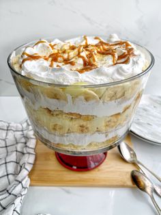 a banana split trifle with whipped cream and caramel drizzle