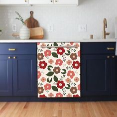 a kitchen with blue cabinets and white counter tops has an orange flower pattern on the door