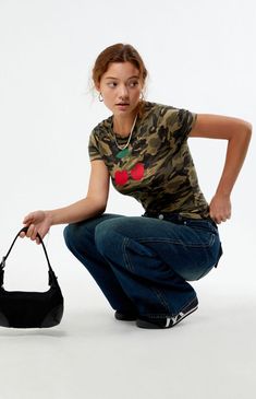 Add a playful edge to your wardrobe with the Camo Cherry Baby T-Shirt from PS / LA. Featuring a camouflage print paired with a cherry front graphic, this tee stands out with its short sleeves and crew neckline. The slightly cropped fit enhances its trendy appeal, making it a versatile piece for casual styling.Camo print baby teeShort sleevesCrew necklineCherry graphicCropped lengthFitted95% cotton, 5% spandexMachine washableModel is wearing a size smallModel measurements: 5’6.5” height, 32” bust, 23” waist, 35” hips PS / LA Womens Camo Cherry Baby T-Shirt - Camouflage Neutral size XS Trendy Camouflage Crew Neck T-shirt, Trendy Camouflage T-shirt For Summer, Camouflage Fitted Short Sleeve Tops, Fitted Camouflage Short Sleeve Tops, Fitted Camouflage Tops With Short Sleeves, Cherry Baby, Womens Camo, Camouflage Print, Top Graphic Tees