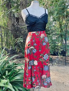 Elevate your vintage fashion collection with this Vintage Red Floral Long Skirt, a pretty and captivating piece that's sure to turn heads. This vintage skirt features a beautiful red floral pattern, a convenient zipper closure at the back, and a comfortable fit suitable for sizes small. Key Features: Vintage Elegance: This skirt captures the timeless charm of vintage fashion. Captivating Floral Pattern: The red floral pattern adds a touch of romantic allure to your ensemble. Easy Zipper Closure: Flowy Floral Print Rayon Skirt, Flowy Rayon Maxi Skirt With Floral Print, Summer Flowy Red Maxi Skirt, Red Flowy Maxi Skirt For Summer, Flowy Red Maxi Skirt For Summer, Fitted Red Maxi Skirt For Summer, Spring Floral Print Rayon Maxi Skirt, Floral Print Tiered Maxi Skirt In Rayon, Red Flowy Maxi Skirt For Spring