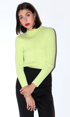 This lime green knit sweater features a high mock neck. Style it to your liking with any complementary colors or your favorite outerwear. Ribbed mock neck Fitted Long sleeves Turtleneck Self: 98% Polyester, 2% Spandex Length: 23 3/4" Chest: 13" Hand wash in cold water. Lay flat to dry. Model is wearing a size small Style #: G2210WT5825 Spring Textured Knit Turtleneck, Trendy Spring Knit Turtleneck, Fitted Textured Knit Turtleneck With Funnel Neck, Spring Knit Turtleneck, Spring High Neck Knit Turtleneck, Knit High Neck Turtleneck For Spring, Spring Knit Turtleneck Top, Spring Knit Mock Neck Turtleneck Top, Green Turtleneck Top