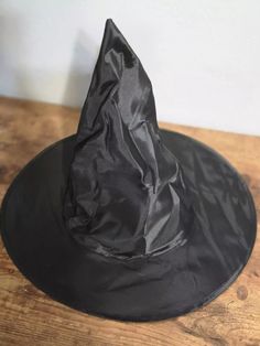 This is a costume party Halloween witch hat base that can be easily decorated or worn as is for a more classic witch look. Lightweight so ideal for lightweight decorations. THE PICTURES OF THE PREMADE HATS ARE FOR REFERENCE ONLY THEY ARE HATS I'VE MADE IN THE PAST. SO PLEASE DON'T EXPECT TO GET A PREMADE HAT. I added structure to the underside of the hat before decorating because this is a super lightweight hat. Approximately: 15 inches across the rim, 8 inches across center opening and 13 inche Halloween Novelty Costume Hat With Wide Brim, Halloween Novelty Wide Brim Costume Hat, Novelty Wide Brim Halloween Costume Hat, Black Witchy Wide Brim Costume Accessories, Spooky Black Costume Hats And Headpieces For Halloween, Wide Brim Costume Accessories For Halloween Party, Black Wide Brim Costume Hat For Cosplay, Spooky Hats For Halloween Costume Party, Witchy Hats For Halloween Costume Party