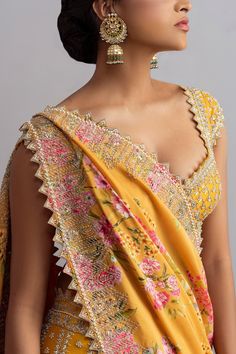 Honey yellow raw silk lehenga with cutdana work, temple border, floral motifs, striped pattern and cutwork hem. Comes with embroidered blouse and floral print silk dupatta.
Components:3
Embroidered, Printed
Neckline:Sweetheart
Sleeve Length:Cap
Fabric:Raw Silk; Dupatta: Silk
Color:Yellow
Plunging neck
Tie-up cutout back
Kamar tassels
Cutwork detail
 - Aza Fashions Silk Pre-draped Saree With Gota Work For Wedding, Wedding Raw Silk Sets With Motifs, Yellow Pre-draped Saree For Transitional Wedding Season, Raw Silk Wedding Sets With Motifs, Wedding Sets In Raw Silk With Motifs, Wedding Sets With Motifs In Raw Silk, Unstitched Yellow Blouse Piece For Wedding, Unstitched Wedding Choli With Motifs, Yellow Dola Silk Pre-draped Saree For Wedding