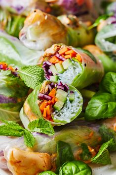 several vegetables wrapped in leafy greens on a plate