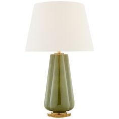 a green table lamp with a white shade