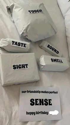 four bags of food sitting on top of a bed with the words taste, sound and smell written on them