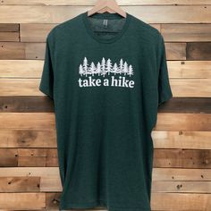 TAKE A HIKE T-SHIRT | Take a Hike Graphic Tee Shirt | Vintage Shirt | Ultra Soft Graphic Tee | T-shirt Men | Cool Shirts ntroducing our "Take A Hike" tee - more than just a t-shirt, it's an invitation to embrace the great outdoors. This isn't your ordinary tee; it's a wearable ode to the spirit of adventure. Why You'll Love It: ✨ Comfort for the Journey: Crafted with your comfort in mind, this tee isn't just about fabric; it's your companion for every step of the hiking journey. 😊 Nature Lover's Choice: A t-shirt that speaks to your love for the outdoors. Perfect for those who find solace, joy, and adventure in the beauty of nature. 👕 Adventure-Ready Style: Whether you're hitting the trails or just want to carry the essence of nature with you, this t-shirt effortlessly blends comfort wit Take A Hike Shirt, Graphic Tee T-shirt With Crew Neck For Hiking, Green T-shirt For Outdoor Activities, Crew Neck T-shirt With Letter Print For Hiking, Green Crew Neck T-shirt For Outdoor Activities, Green Crew Neck T-shirt For Outdoor, Sporty Crew Neck T-shirt For Outdoor, White Pre-shrunk T-shirt For Hiking, Sporty Outdoor Tops With Screen Print