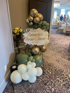 an arrangement of balloons, flowers and a sign that says antomete's bridal shower