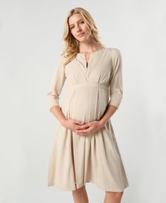 Where power meets femininity, the Madeline is the go-to confidence booster in your maternity wardrobe. The stunning pleated skirt ends in an empire waistline perfect for all different kinds of tummy days. Bonus, the skirt hides two HUGE pockets - a mama's best friend. The Sarah's dramatic cuffs, lightly padded shoulders, and adjustable v-neckline with teardrop zip (perfect for nursing) make this an unforgettable statement piece. Its easy, flattering silhouette will make it one of the most effort Breastfeeding Dress, Maternity Black Dress, Maternity Wardrobe, Feminine Skirt, Workwear Essentials, Maternity Nursing Dress, Pregnancy Wardrobe, Empire Waistline, Photoshoot Dress