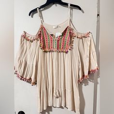 Velzera Embroidered Bohemian Style Tunic/Beach Cover-Up/Mini Dress. Brand New With Tags! Gorgeous Beige With Multi Colored Embroidered Design And Multi Colored Pompoms. Has Off Shoulder Style With Extra Wide Sleeves & Adjustable Shoulder Straps. Size 1x Fall Tunics, Off Shoulder Style, Bohemian Tunics, Embroidered Tunic Dress, Striped Tunic Dress, Embroidered Tunic Top, Flared Sleeves Top, Off Shoulder Fashion, Ethnic Print