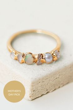 A nuanced take on classic ombre, this iridescent ombre ring features a collection of shimmering stones in various shades of white. With Herkimer diamond, pearl, quartz, opal, moonstone, and white topaz stones, these raw gemstones range from warm creams to the coolest whites. Stackable Moonstone Ring In Fine Jewelry Style, Yellow Gold Moonstone Promise Ring, Elegant Iridescent Birthstone Jewelry, Opal Moonstone Ring For Anniversary, Iridescent Fine Jewelry Ring For Anniversary, Delicate Opal Ring For Anniversary, Elegant Iridescent Opal Ring For Anniversary, Elegant Iridescent Crystal Ring For Wedding, Elegant Iridescent Crystal Wedding Ring