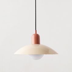 an orange and white light hanging from a ceiling