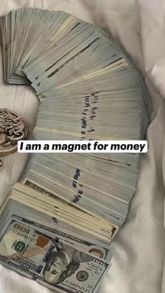 a pile of money sitting on top of a bed