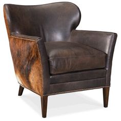 a brown leather chair with wooden legs