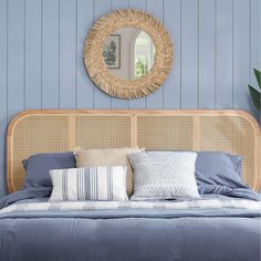 a bedroom with blue walls and wicker headboard