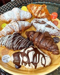 a wooden plate topped with different types of pastries