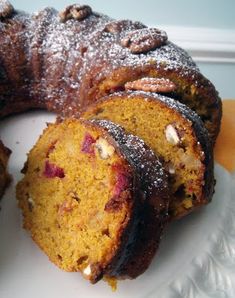 a bundt cake on a white plate with powdered sugar