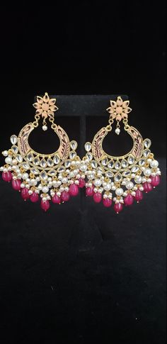 "This beautiful Kundan earrings set has an excellent finish and gives out an exquisite sense of style. If you are looking for an amazing Fashion Jewelry set for special occasions such as Anniversary, Engagement, Party, Wedding, gifting, then your search ends here. This handmade Indian Jewelry is best to wear for traditional ceremonies or Indian weddings. This bridal jewelry has an ethnic finish. It has Cubic Zircon stones with semi-precious ruby and emeralds. It is a Bollywood style one-gram jew Elegant Kundan Danglers With Dangling Beads, Elegant Kundan Danglers With Beads, Elegant Kundan Chandelier Earrings With Dangling Beads, Traditional Festive Beaded Pearl Drop Earrings, Traditional Festive Beaded Earrings With Pearl Drop, Elegant Diwali Danglers With Dangling Beads, Elegant Danglers With Dangling Beads For Diwali, Festive Elegant Dangling Bead Earrings, Festive Elegant Earrings With Dangling Beads