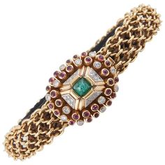 For Sale on 1stdibs - Unique bracelet finely crafted in 18K Yellow Gold with beautiful clasp, centering sugarloaf Emerald, surrounded by cabochon Rubies and diamonds. Signed Fine Jewelry Bracelet With Cabochon, Jeweled Yellow Gold Bracelets For Formal Occasions, Yellow Gold Jeweled Bracelets For Formal Occasions, Yellow Gold Jeweled Bracelet For Formal Occasions, Elegant Jeweled Yellow Gold Bracelet, Formal Yellow Gold Jeweled Bracelets, Luxury Diamond Jeweled Bracelets, Luxury Jeweled Yellow Gold Bracelets, Luxury Cabochon Bangle Jewelry