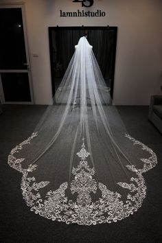 a wedding veil is shown on the floor in front of an entrance to a building