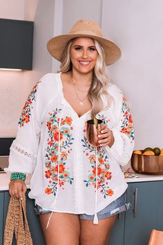 Plus Size - Dress for spring in our darling white 'Dune Dreaming' top featuring lightweight material with gorgeous blue, green, and red/orange hued embroidered floral detailing, a v-cut neckline with a tie closure, long loose sleeves with elastic band cuffs, and a relaxed silhouette that falls into a straight hemline! Measurements 1XL : Bust 50", Hip 52", Length 25", Sleeve Length 25.5", Waist 51". 2XL : Bust 52", Hip 54", Length 26", Sleeve Length 26", Waist 53". 3XL : Bust 54", Hip 56", Length Multicolor Embroidered V-neck Top For Vacation, V-neck Blouse With Multicolor Embroidery For Vacation, Floral Embroidered V-neck Blouse For Vacation, Floral Embroidered V-neck Top For Brunch, V-neck Tops With Floral Embroidery For Brunch, V-neck Top With Floral Embroidery For Brunch, White Embroidered Top For Brunch, White Embroidered Top For Summer Brunch, Spring Vacation White Embroidered Top