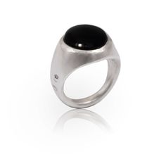 Carved in the late 1980’s, The Signet Dome Ring represents one of Alex Streeter’s rare forays into minimalism. A solid piece of sterling silver set with a large 15mm buff-top cabochon, the Signet Dome remains sleek while still delivering big impact. This ring’s smooth, universal shape and low-profile stone make it perfect for long-term daily wear. Now available with your choice of Lapis Lazuli or Black Onyx Black Onyx said to bring strength and courage to its wearer, while beautiful Lapis lazuli Black Gemstone Signet Ring, Formal Black Cabochon Signet Ring, Luxury Onyx Round Signet Ring, Classic Onyx Signet Ring With Polished Finish, Silver Onyx Gemstone Signet Ring, Domed Ring, Black Onyx, Lapis Lazuli, Onyx