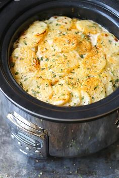 a crock pot filled with food sitting on top of a table