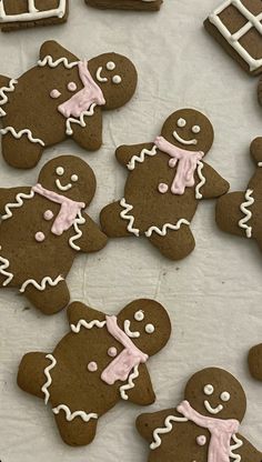 some very pretty decorated cookies with icing on it's faces and hands in the shape of gingerbreads