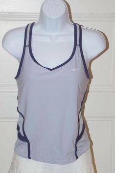 NIKE Women's Light Blue Dri-Fit Racer Back V-Neck Tank Top Navy Blue Trim Sz S NIKE Women's Light Blue Dri-Fit Racer Back V-Neck Tank Top Navy Blue Trim Sz S Details NIKE Women's Light Blue Dri-Fit Racer Back V-Neck Tank Top Navy Blue Trim Sz S Dri-FIT fabric to wick sweat away and help keep you dry and comfortable Racerback for full range of motion self bra Mesh back panels for enhanced breathability Flat-seams to help minimize chafing Nike logo embroidered on front Brand: Nike Size: S Material Blue Sporty Tops For Tennis, Sporty Blue Tennis Tops, Coraline Dolls, 80's Clothes, Tennis Tank Tops, Sport Clothing, Nike Tank Top, Tennis Tops, Workout Fits