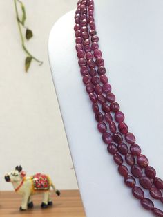 Stone : Ruby Size : 4.5 by 5.5 mm to 7.5 by 9.5 mm Beads Shape : Oval (smooth) Weight : 310 Carats Color : Red Gemstone are made in Billions of Years in the Womb of Earth. Gemstones connect us widely to the universe and spirits. All the photographs of the item are captured in natural daylight. The photographs are uploaded without any enhancements or editing. All photographs depicts the color of Gemstone Accurately, color may vary slightly. All the items from our shop are genuine and natural. Eac Oval Gemstone Beads For Jewelry Making, Oval Gemstone Beaded Necklaces For Jewelry Making, Faceted Oval Beads For Jewelry Making, Spiritual Oval Gemstone Beads, Polished Oval Beads Gems And Cabochons For Gift, Elegant Gemstone Oval Beads, Oval Faceted Beads For Jewelry Making, Oval Polished Beads For Gifts, Oval Natural Stone Beads For Gifts